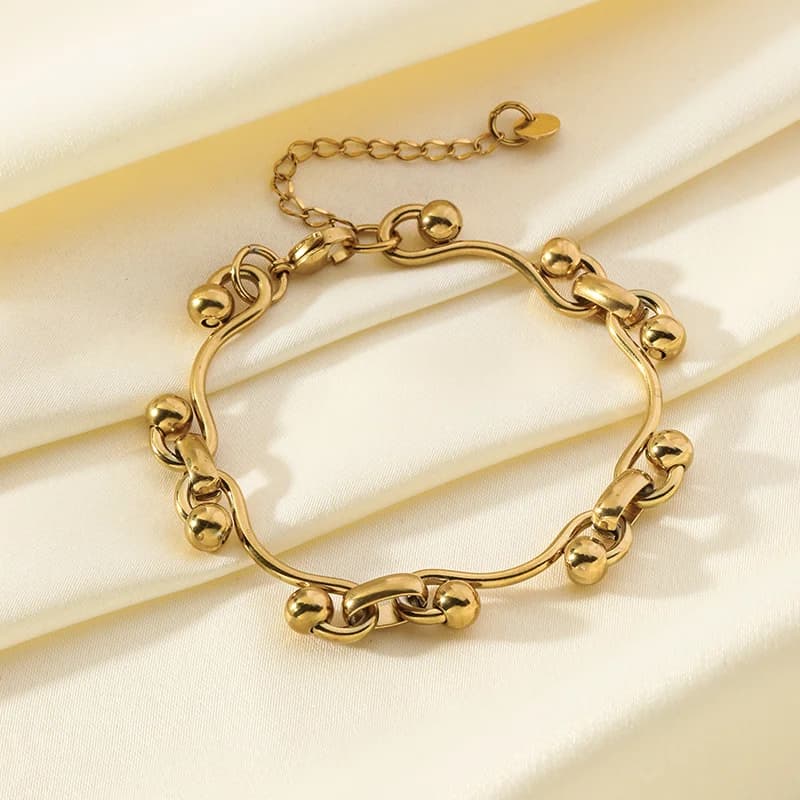 Pulsera rígida de acero inoxidable 316L con dije de corazón color dorado